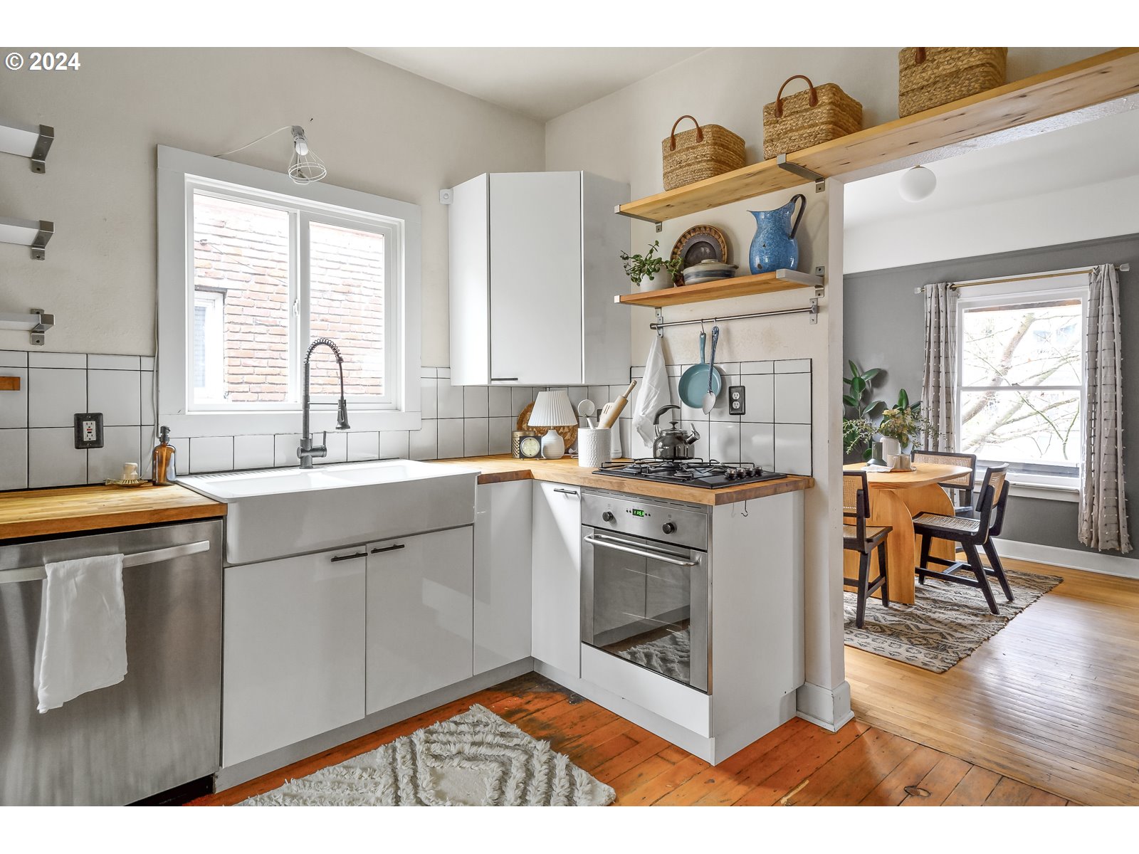 1518 North Webster Street Portland, OR 97217 - Photo 10 of 38 a kitchen with stainless steel appliances granite countertop a stove a sink and a microwave