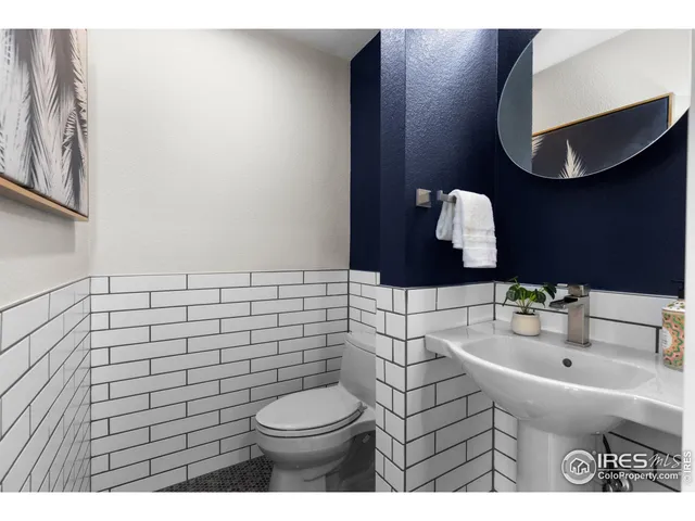 a bathroom with a sink mirror and toilet