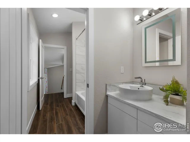 a bathroom with a sink vanity and a mirror