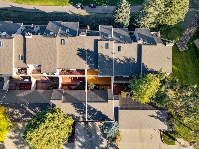 an aerial view of a house with a yard and balcony