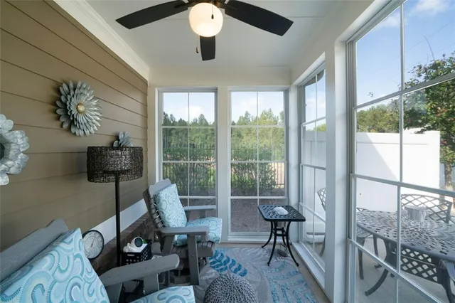 a living room with furniture and a floor to ceiling window