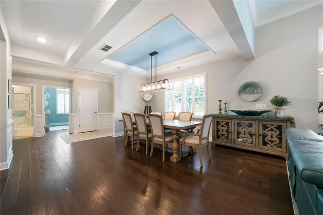 a view of a a dining room with furniture window and wooden floor
