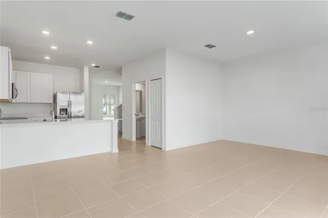 a kitchen with kitchen island a sink stainless steel appliances and cabinets