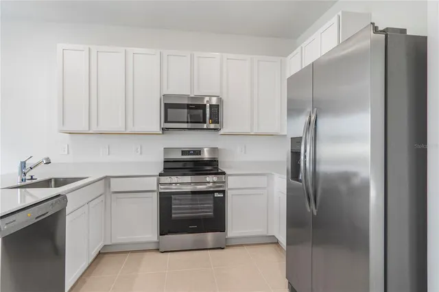 a kitchen with a refrigerator stove and microwave