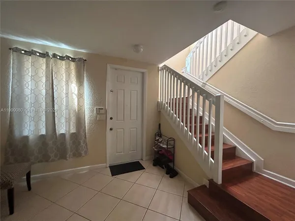 a view of entryway with stairs and wooden floor
