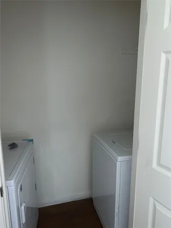 an empty room with wooden floor and a window