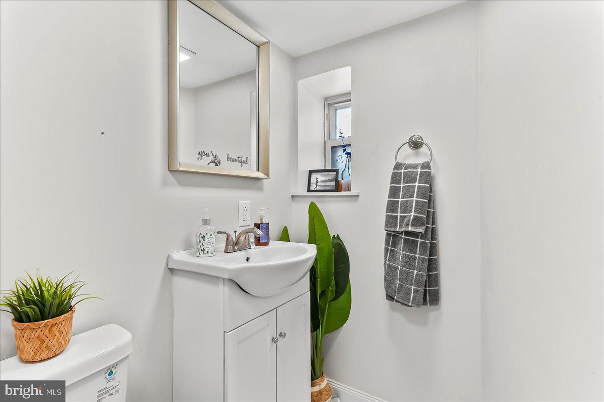 5348 West Berks Street Philadelphia, PA 19131 - Photo 16 of 18 a bathroom with a sink toilet and a mirror