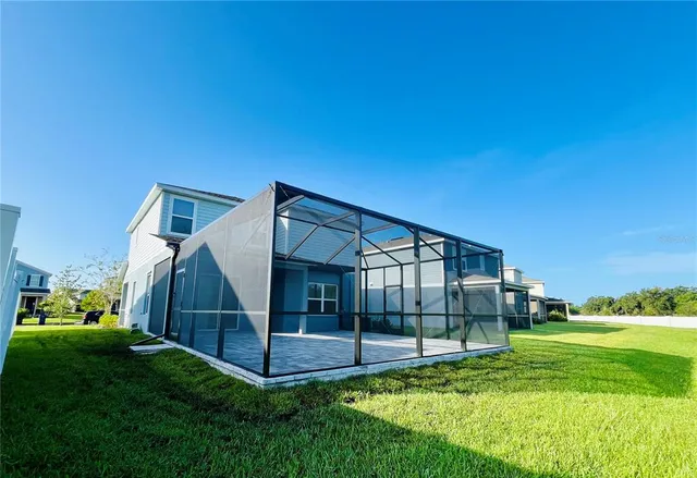a view of house with backyard and porch