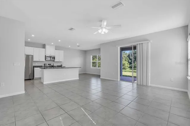 a view of kitchen with refrigerator and window