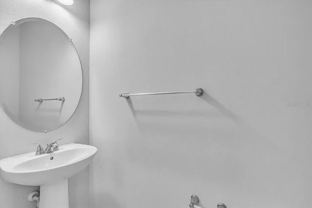 a bathroom with a sink a mirror and a shower