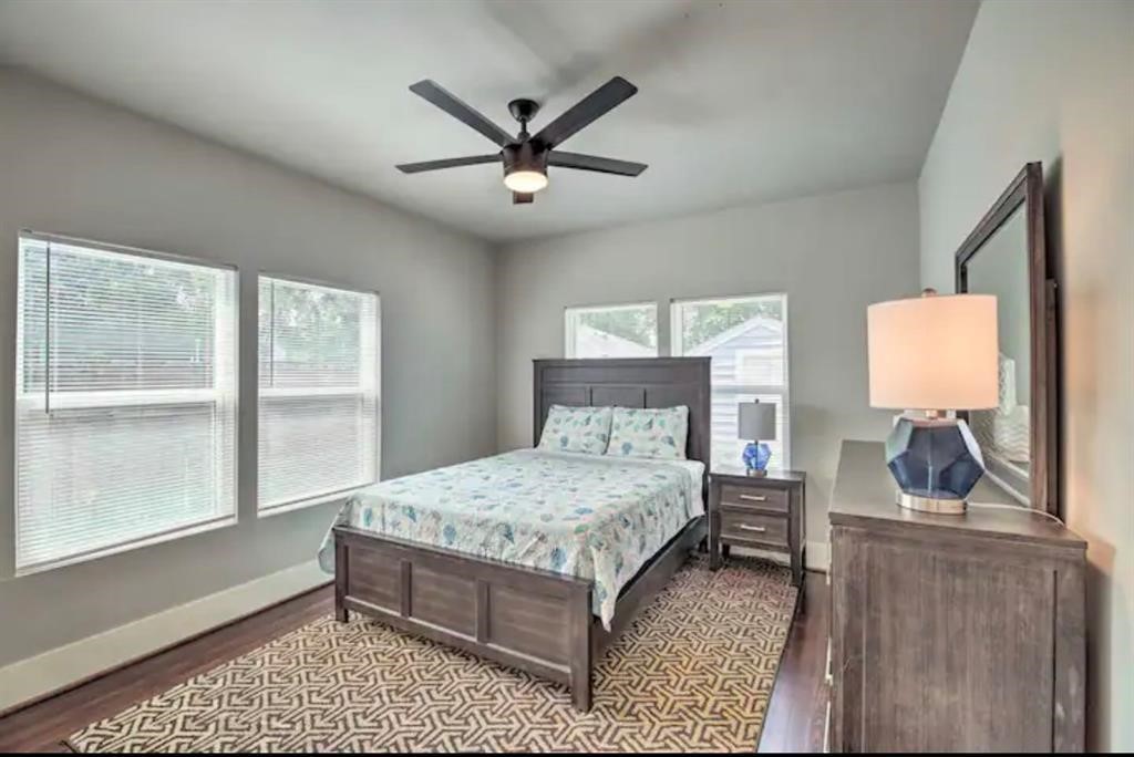 5224 Leeland Street Houston, TX 77023 - Photo 14 of 18 a bedroom with a large bed and a window