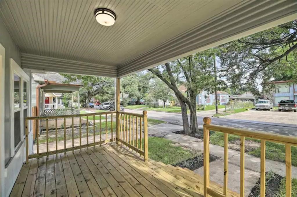 5224 Leeland Street Houston, TX 77023 - Photo 2 of 18 a view of a porch with wooden floor and fence