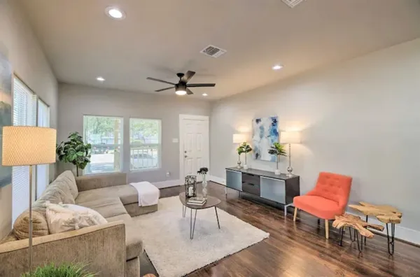 a living room with furniture and a chandelier
