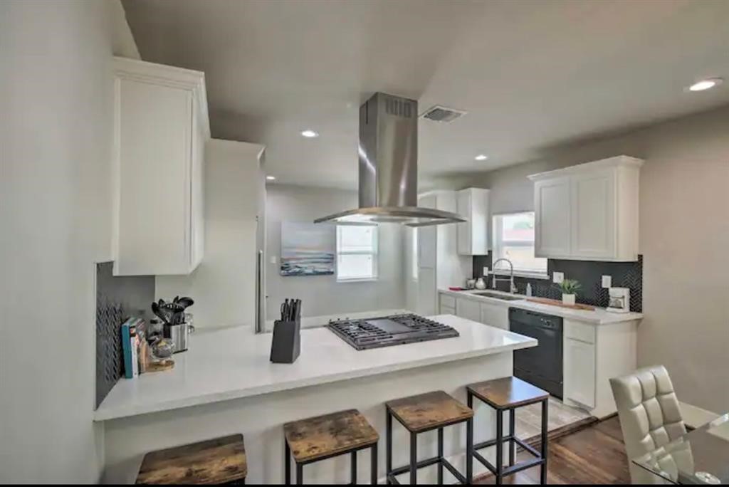 5224 Leeland Street Houston, TX 77023 - Photo 7 of 18 a kitchen with a table chairs stove and cabinets