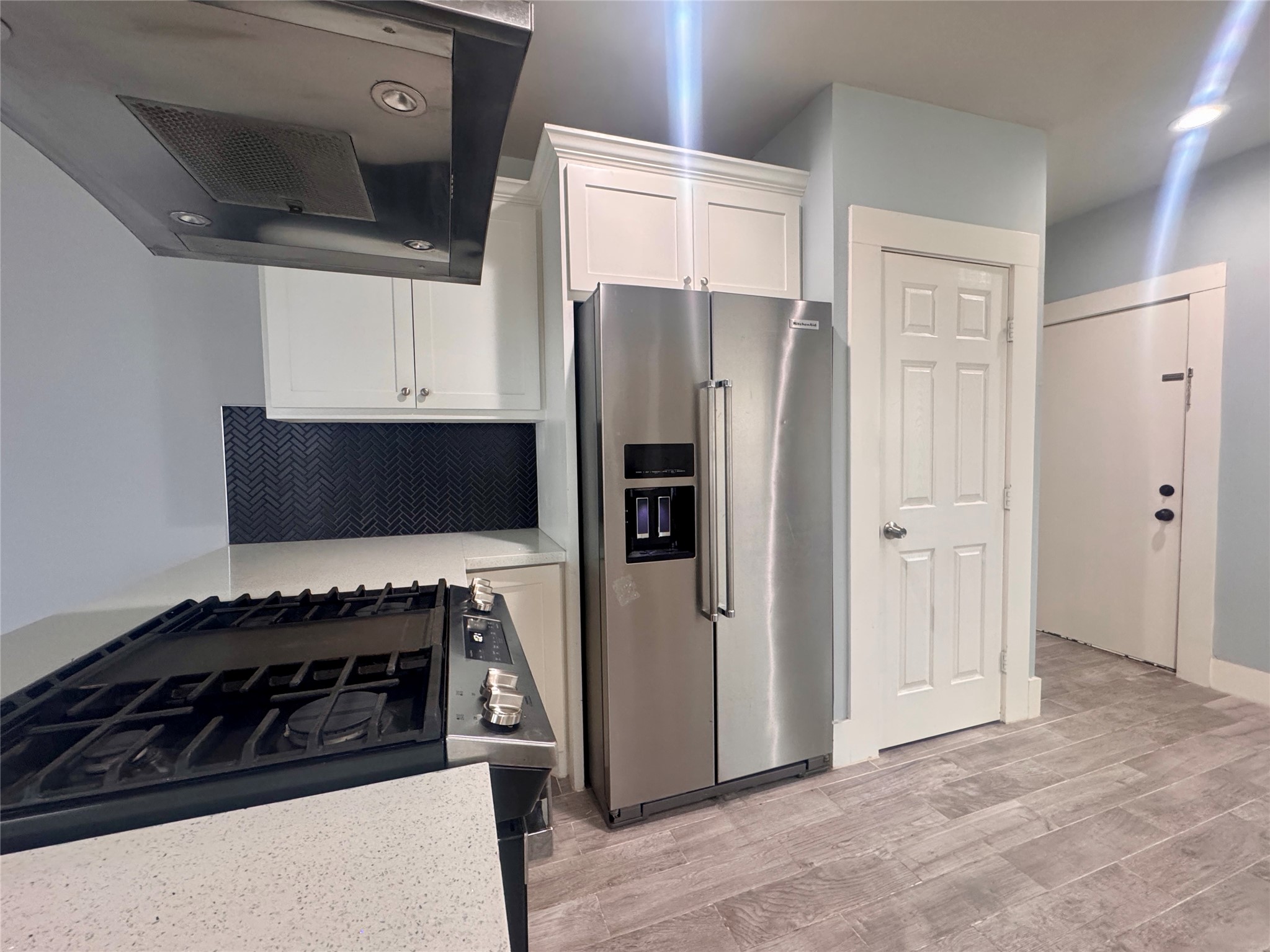 5224 Leeland Street Houston, TX 77023 - Photo 9 of 18 a kitchen with stainless steel appliances a refrigerator and a stove top oven