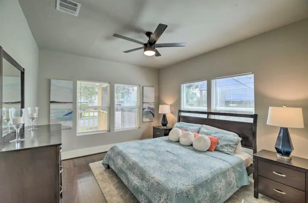 5224 Leeland Street Houston, TX 77023 - Photo 10 of 18 a bedroom with a large bed and a window