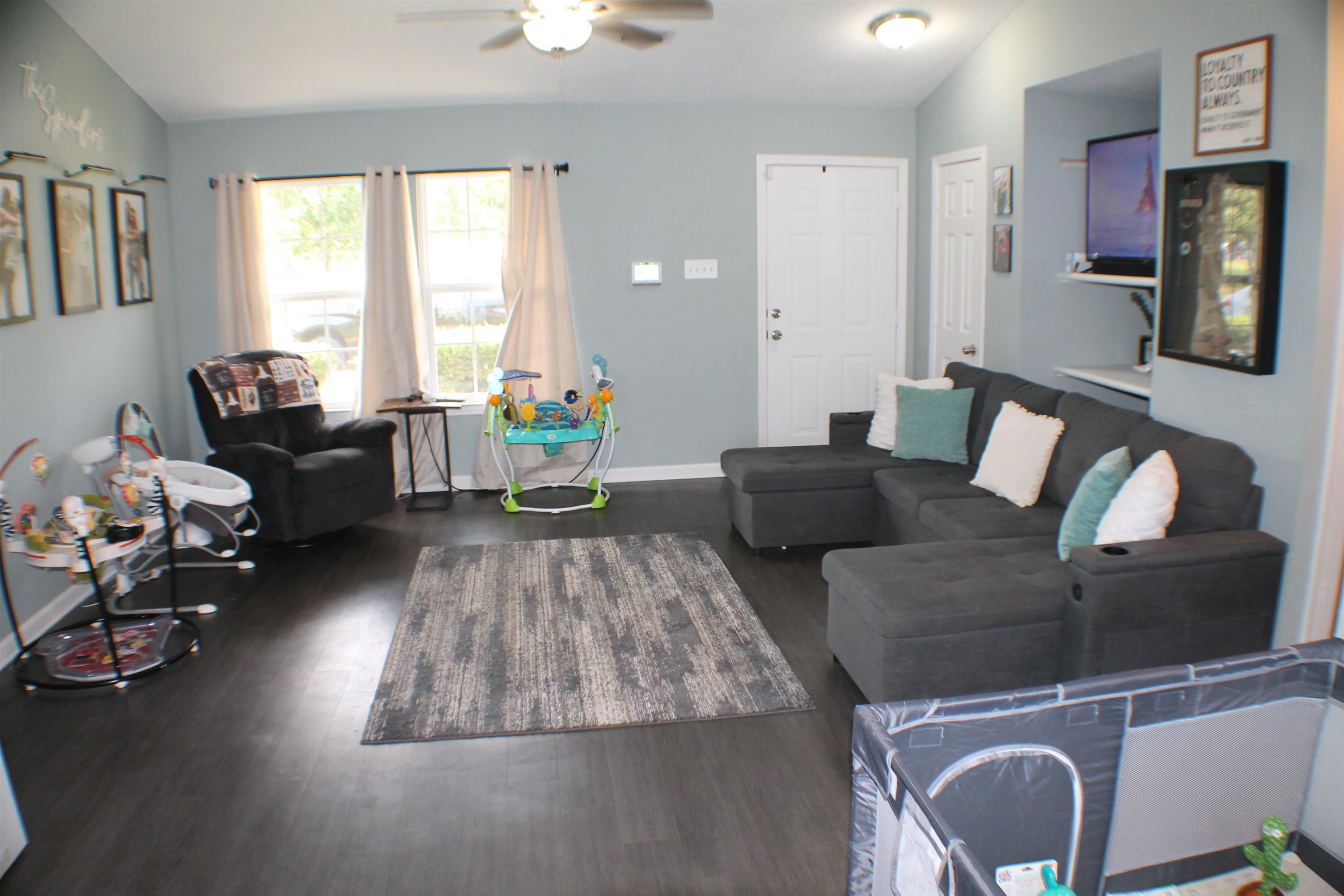 75 Springview Street Mason, TN 38049 - Photo 2 of 14 Living room with dark wood-type flooring, vaulted ceiling, and ceiling fan