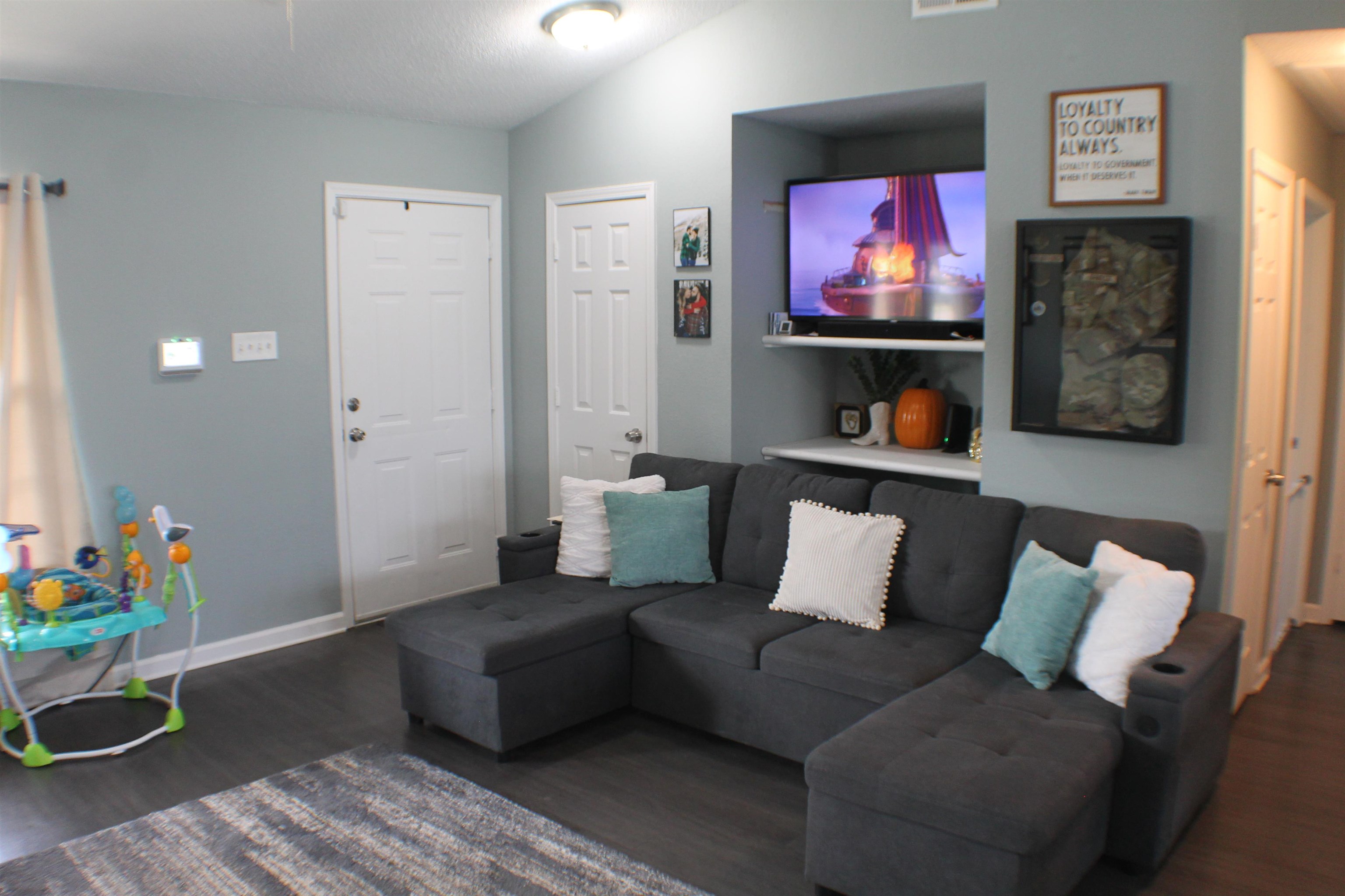 75 Springview Street Mason, TN 38049 - Photo 3 of 14 Living room featuring lofted ceiling and dark hardwood / wood-style flooring