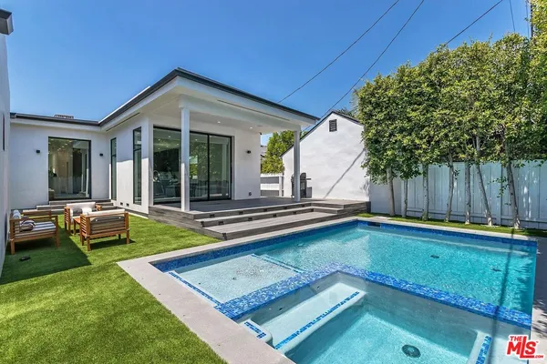 a view of a house with swimming pool and sitting area