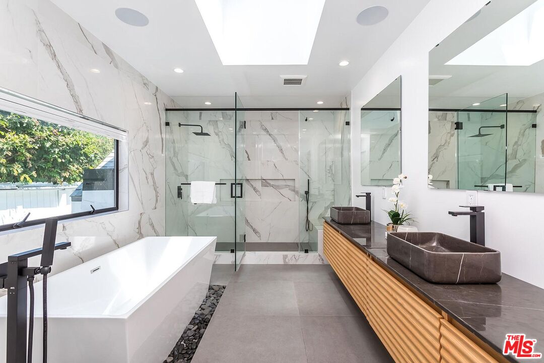 1948 South Point View Street Los Angeles, CA 90034 - Photo 15 of 27 a spacious bathroom with a double vanity sink a mirror and a bathtub