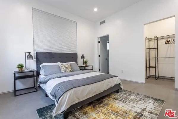 a bedroom with a bed and a couch