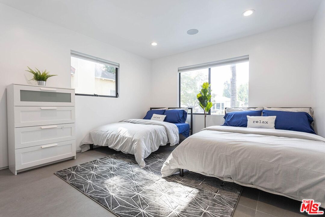 1948 South Point View Street Los Angeles, CA 90034 - Photo 20 of 27 a bedroom with two beds and a window