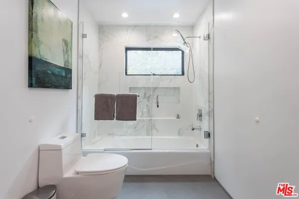 a bathroom with a toilet a sink and bathtub