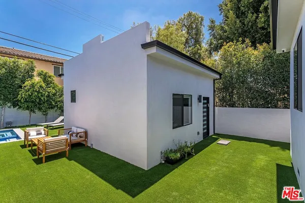 a view of backyard with a table and chair