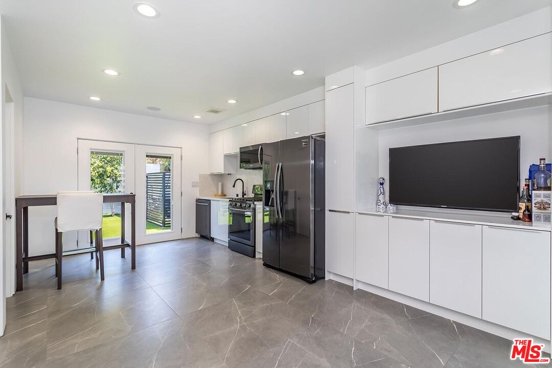 1948 South Point View Street Los Angeles, CA 90034 - Photo 26 of 27 a living room with furniture and a flat screen tv