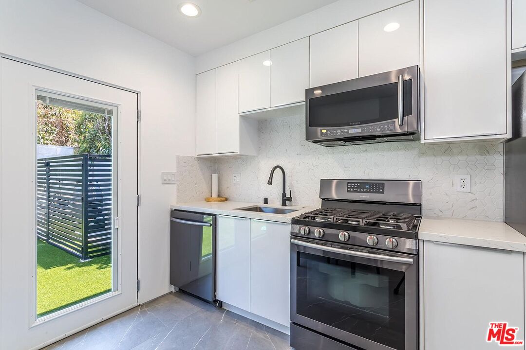 1948 South Point View Street Los Angeles, CA 90034 - Photo 27 of 27 a kitchen with a stove and a microwave