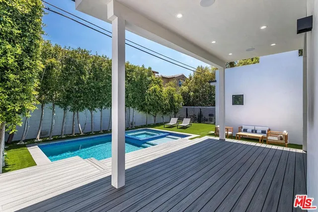 a view of swimming pool with a lounge chairs