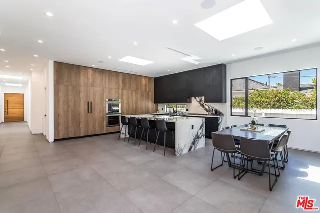 a kitchen with stainless steel appliances kitchen island granite countertop a sink and cabinets
