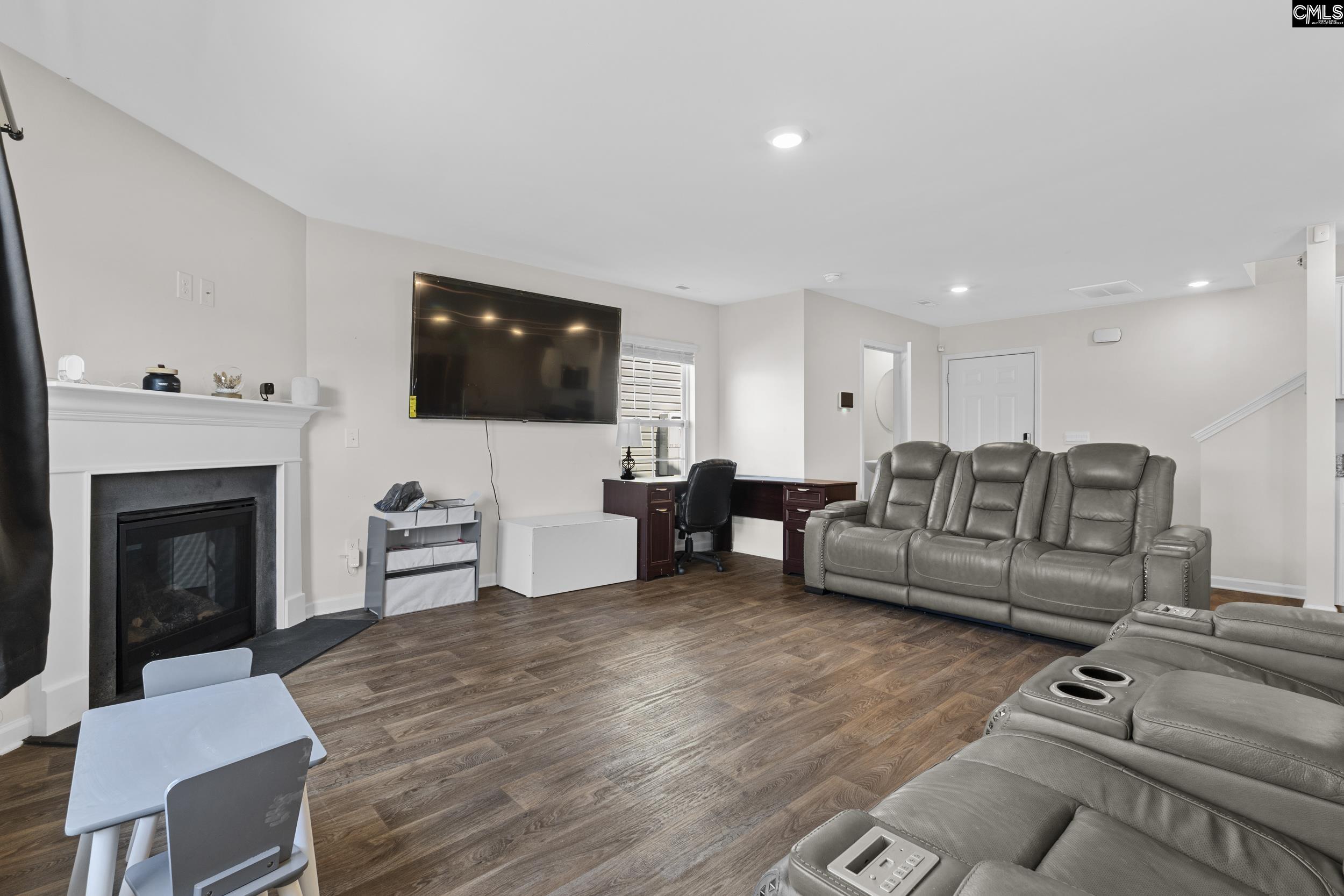 2097 Elmridge Road Columbia, SC 29209 - Photo 2 of 9 a living room with furniture a flat screen tv and a fireplace