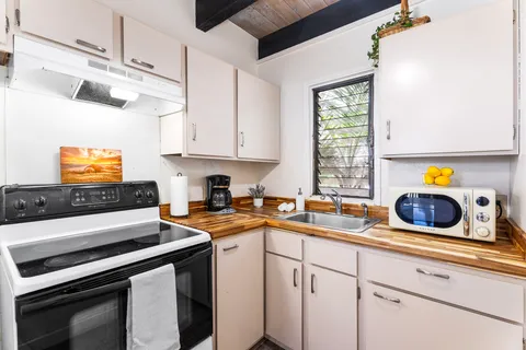 a kitchen with a sink stove and microwave