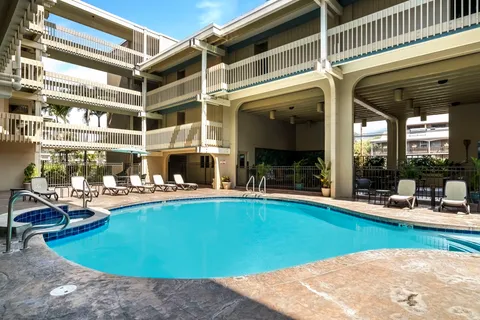 a view of a swimming pool with outdoor seating