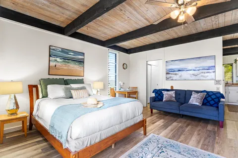 a bedroom with a bed couch and window