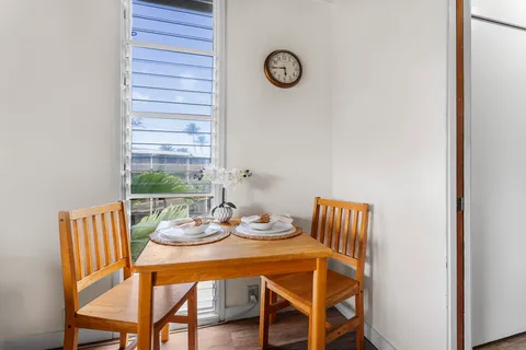 a dining room with furniture and a window