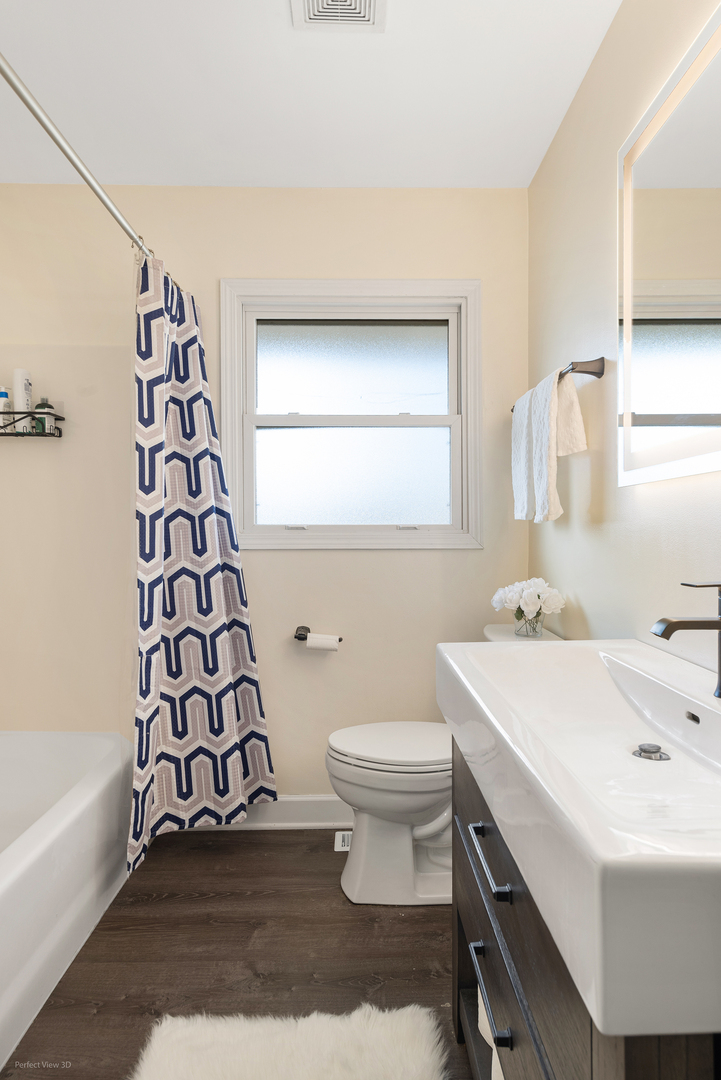 11N958 Almora Terrace Elgin, IL 60124 - Photo 11 of 26 a bathroom with a sink toilet and shower