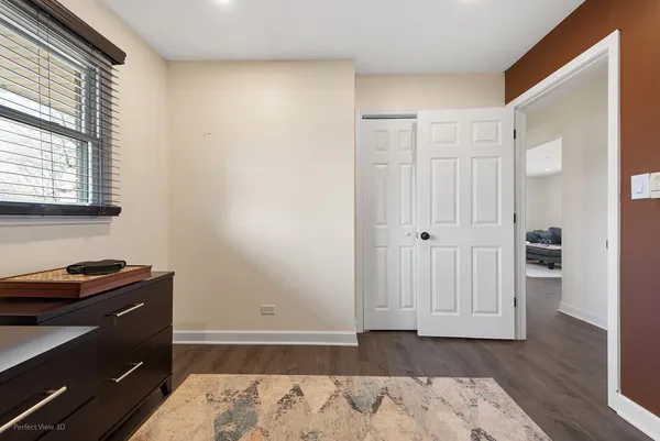a view of a room with wooden floor and cabinet