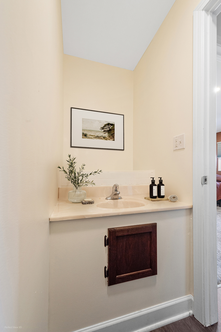 11N958 Almora Terrace Elgin, IL 60124 - Photo 16 of 26 a bathroom with a sink and a mirror