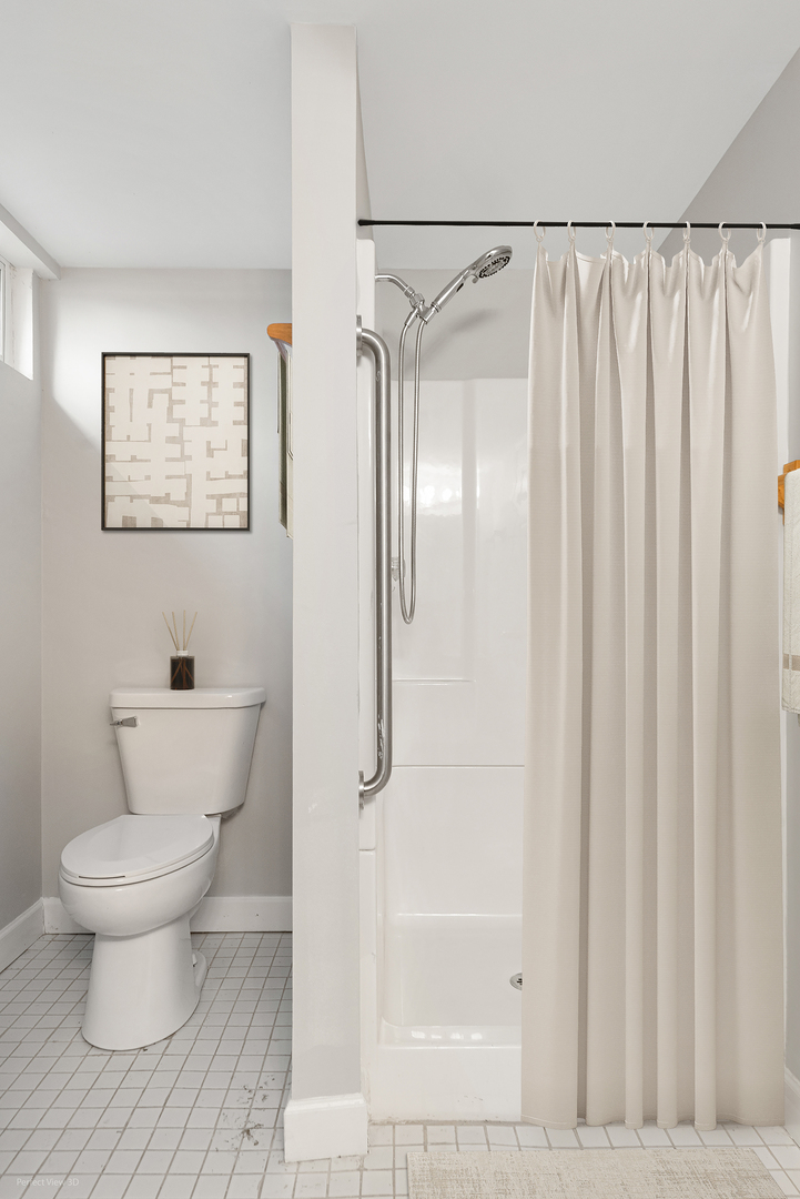 11N958 Almora Terrace Elgin, IL 60124 - Photo 22 of 26 a bathroom with a toilet and a shower