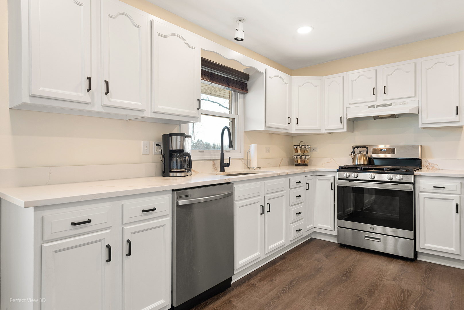 11N958 Almora Terrace Elgin, IL 60124 - Photo 7 of 26 a kitchen with cabinets stainless steel appliances and sink