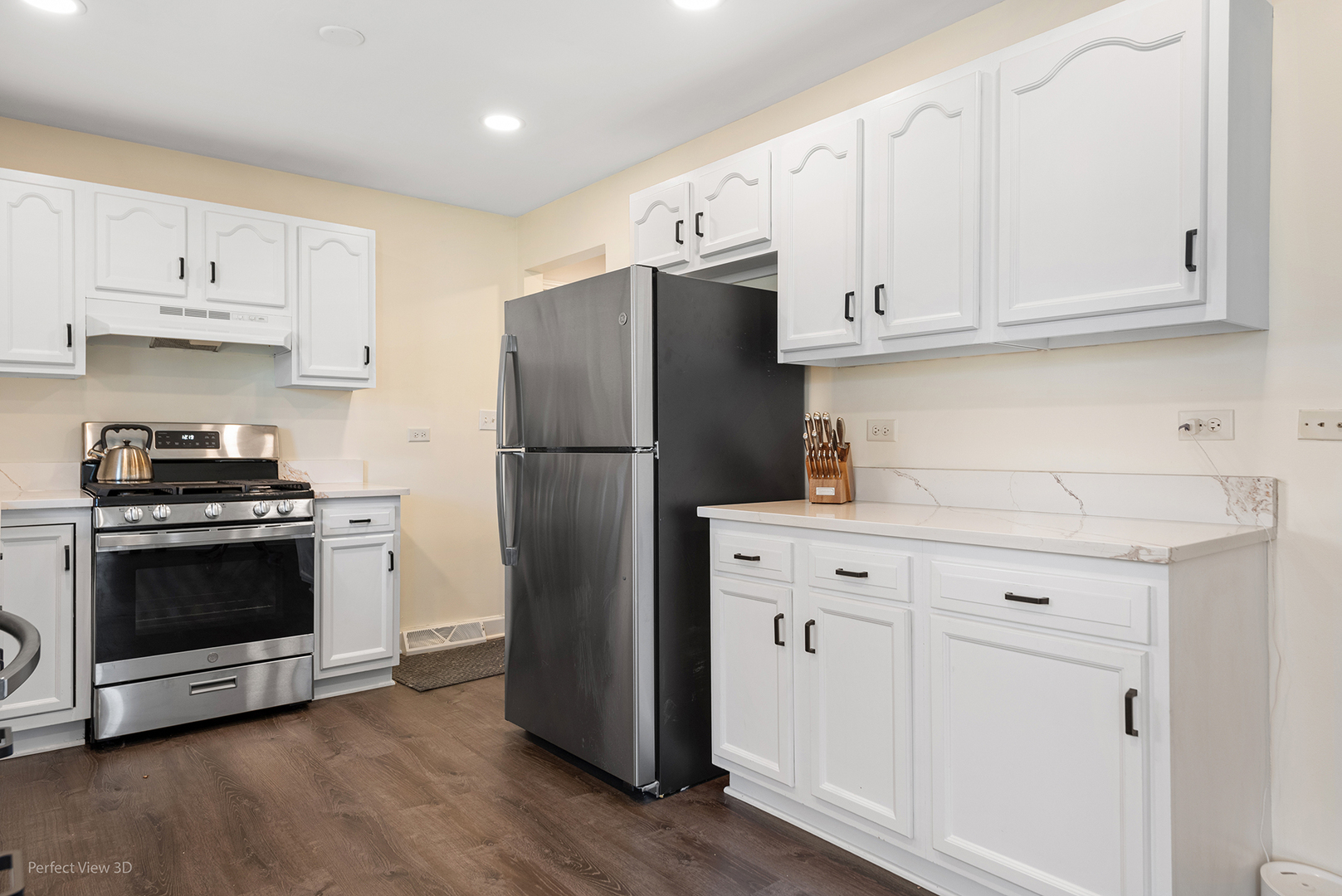 11N958 Almora Terrace Elgin, IL 60124 - Photo 8 of 26 a kitchen with cabinets stainless steel appliances and wooden floor