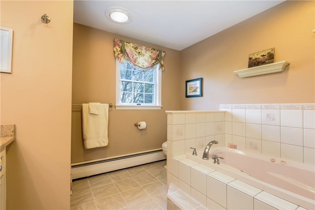 185 Wickham Road North Kingstown, RI 02852 - Photo 23 of 38 Newly tiled master bath with Jacuzzi tub, shower, and updated granite vanity!