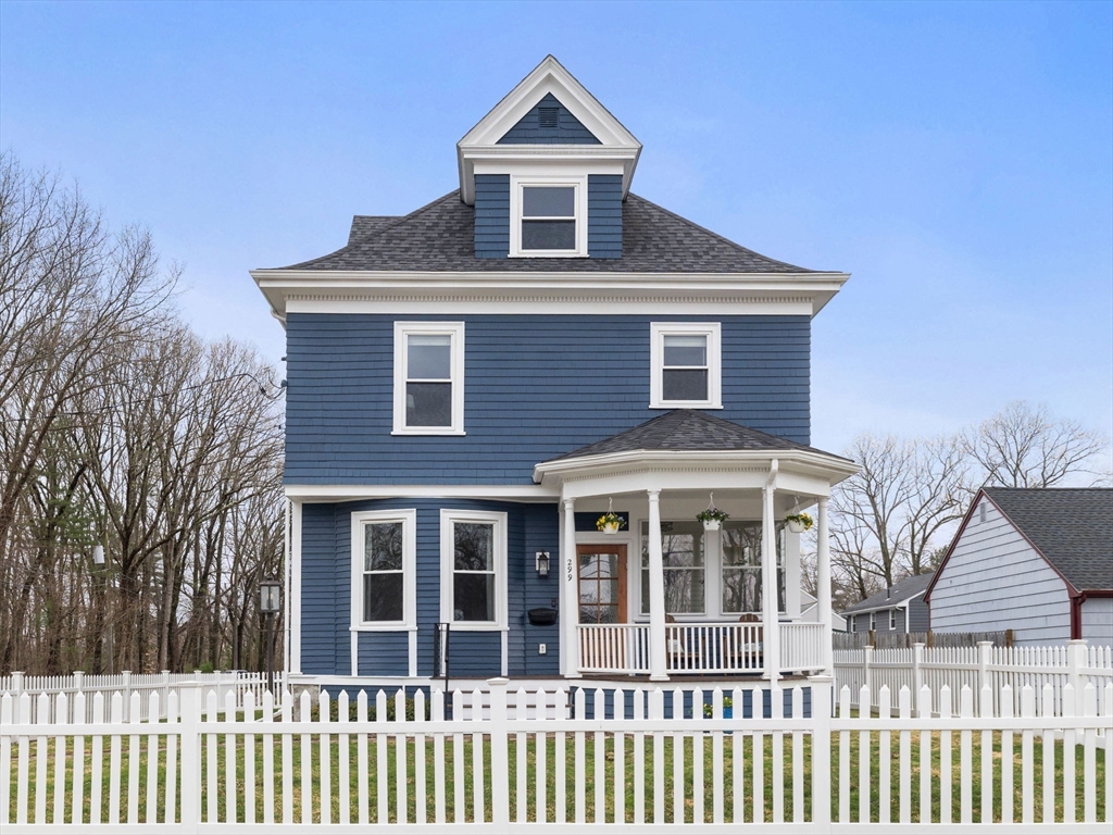 299 Central Avenue Dedham, MA 02026 - Photo 2 of 39 a front view of a house with a yard