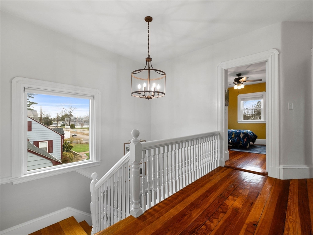 299 Central Avenue Dedham, MA 02026 - Photo 21 of 39 a view of a hallway with wooden floor and stairs