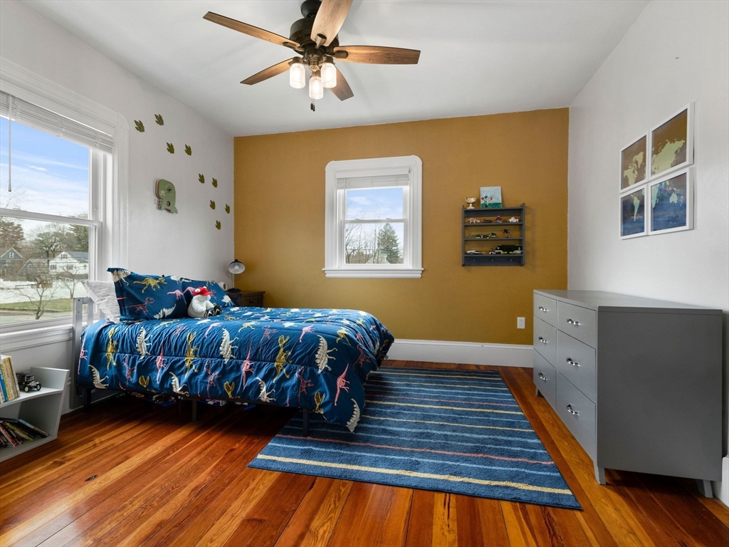 299 Central Avenue Dedham, MA 02026 - Photo 22 of 39 a bedroom with a bed and wooden floor
