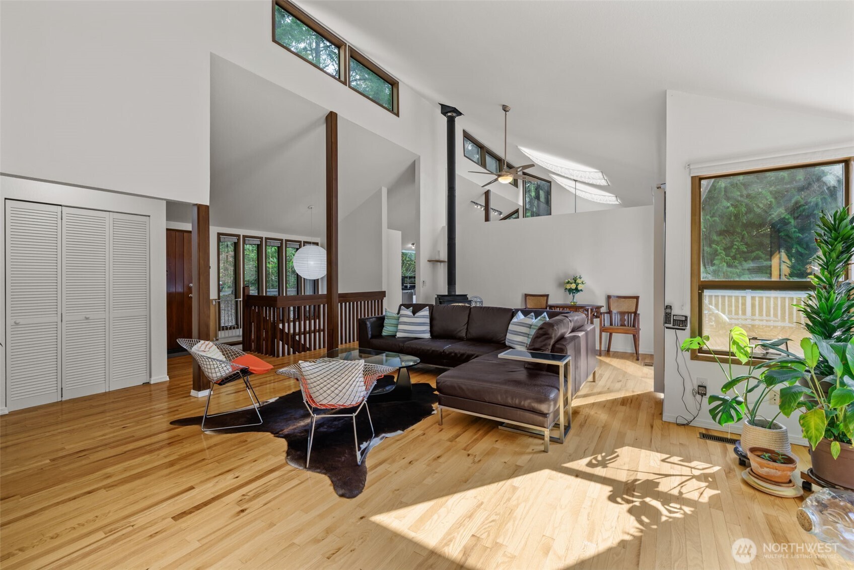 4714 175th Street Southeast Bothell, WA 98012 - Photo 13 of 40 a living room with furniture floor to ceiling window and wooden floor
