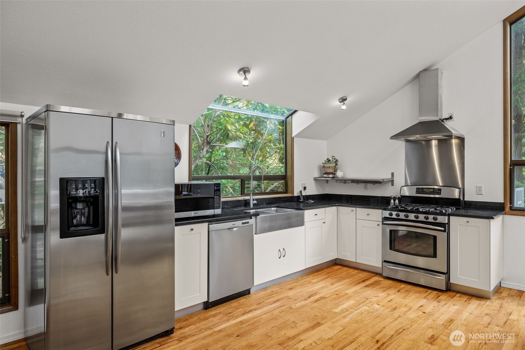 4714 175th Street Southeast Bothell, WA 98012 - Photo 16 of 40 a kitchen with stainless steel appliances granite countertop a stove a refrigerator and a sink