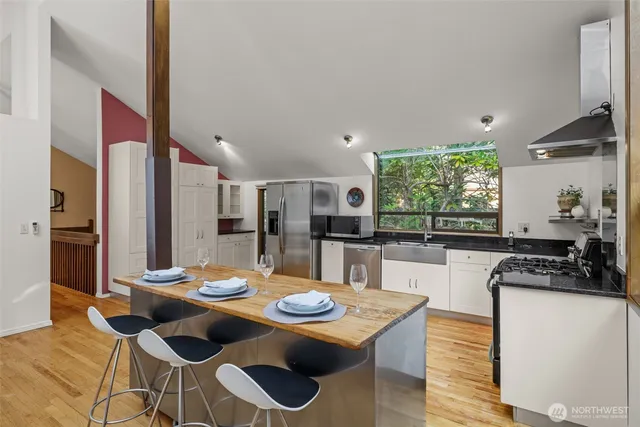 a kitchen with a dining table and chairs